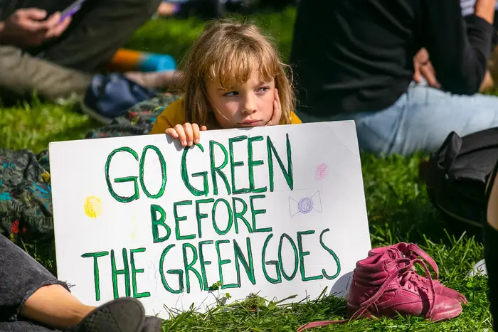 A sign reads: Go green before the green goes